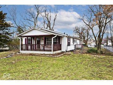 Charming one-story home with a covered porch, burgundy trim, and a well-maintained lawn at 33 W Mill St, New Palestine, IN 46163