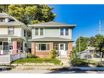 Charming two-story home featuring a brick foundation and light blue siding at 3470 N Kenwood Ave, Indianapolis, IN 46208
