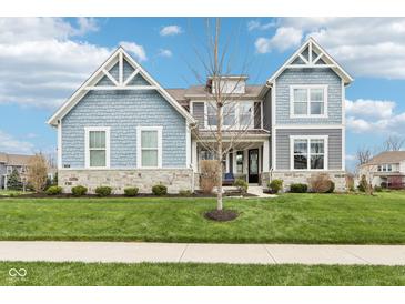 Beautiful two-story home featuring stone accents and a well-manicured lawn at 3645 Conifer Dr, Zionsville, IN 46077