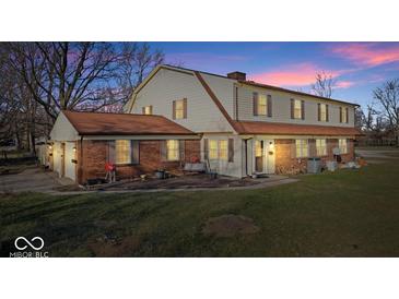 Charming two-story home featuring a brick facade, complemented by a well-manicured lawn and inviting outdoor space at 4814 Lynton Ct, Indianapolis, IN 46254