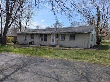 Modest one-story brick home with a cozy feel and a sprawling front yard at 5961 N 200 W, Columbus, IN 47201
