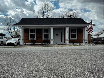 Charming single-story home with wood siding, white columns, and an inviting front porch at 109 S County Line Rd, , IN 47272