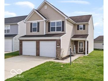 Two-story home with brick accents, an attached two-car garage, and a well-maintained lawn at 15444 Old Pond Cir, Noblesville, IN 46060