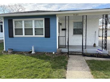 Charming home front porch with decorative iron railings and freshly painted accents at 4121 Fletcher Ave, Indianapolis, IN 46203
