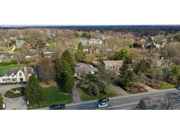 Expansive aerial view of a neighborhood featuring mature trees and well-maintained homes on spacious lots at 7525 N Meridian St, Indianapolis, IN 46260