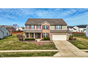 Charming two-story home featuring a brick facade, attached garage, and well-maintained lawn at 8358 Balmoral Dr, Avon, IN 46123