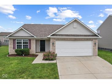 Charming single-story home with attached two-car garage and well-manicured front lawn at 10522 Hunters Crossing Blvd, Indianapolis, IN 46239