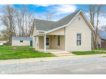 Charming single-story home with vinyl siding and a cozy front porch at 156 S Cross St, Clayton, IN 46118