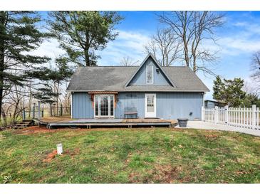 Charming blue home with a deck, white picket fence, and well-maintained lawn on a sunny day at 2025 State Road 47, Lebanon, IN 46052
