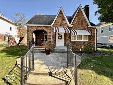 Charming brick home with landscaped front yard, walkway and peaked roofline at 303 S Walnut St, Edinburgh, IN 46124
