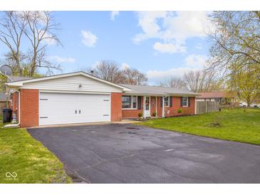 Brick ranch-style home with a well maintained lawn, attached garage, and an asphalt driveway at 3104 S Pisgah Way, Columbus, IN 47203