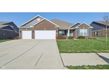 Charming brick home with well-manicured lawn and spacious driveway at 3254 S Ansley Dr, New Palestine, IN 46163