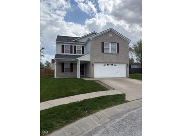 Charming two-story home featuring a brick facade, well-manicured lawn, and a two-car garage at 373 Springfield Cir, Greenwood, IN 46143