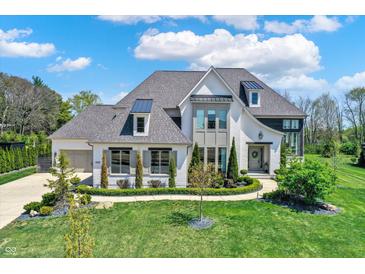 Elegant two-story home boasts a manicured lawn and charming architectural details for curb appeal at 5130 Melbourne Pl, Zionsville, IN 46077