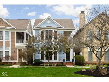 Charming two-story home with light blue siding, bay windows, and well-manicured front lawn at 634 N Senate Ave, Indianapolis, IN 46202