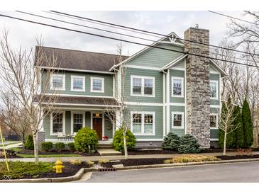 Beautiful two-story home with a stone chimney and inviting front porch at 768 Trailside Dr, Carmel, IN 46032