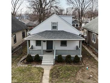 Charming home featuring a cozy front porch and well-maintained landscaping at 1216 N Holmes Ave, Indianapolis, IN 46222