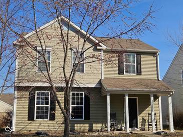 Charming two-story home features a well-maintained lawn and inviting front porch, nestled under a clear blue sky at 13124 S Elster Way, Fishers, IN 46037