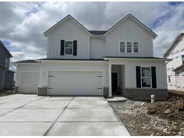 Charming new two-story home featuring a three-car garage and classic black shutters against a bright white facade at 16441 Mount Logan Rd, Noblesville, IN 46060