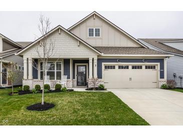 Charming home featuring a well-manicured lawn, a covered front porch, and a neutral color palette at 19668 Mcdonald Pl, Westfield, IN 46074