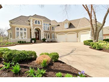 Stately home featuring an arched entry, multi-car garage, manicured landscaping and circular driveway at 2004 Caledonian Ct, Greenwood, IN 46143