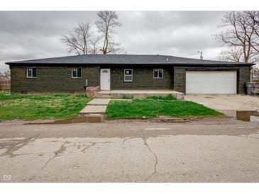 Charming single-story home with a brick exterior, front yard, and attached garage for convenient parking at 2134 Dawson St, Indianapolis, IN 46203