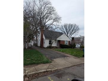 Charming single-Gathering home features a brick chimney and a well-maintained front lawn at , Indianapolis, IN 46220
