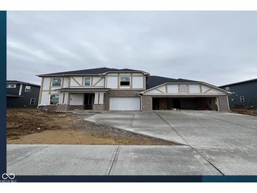 New two-story home featuring brick accents, a spacious driveway, and an attached two-car garage at 3241 Fawn Cir, Brownsburg, IN 46112
