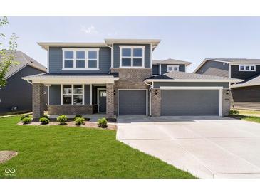 Beautiful two-story home featuring a lawn, grey siding, stone accents and an attached two car garage at 3241 Fawn Cir, Brownsburg, IN 46112