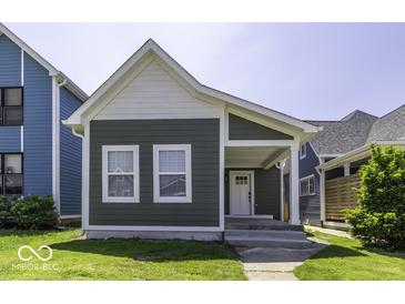 Charming home featuring a covered porch, gray siding and white trim and well-maintained front lawn at 337 E Minnesota St, Indianapolis, IN 46225