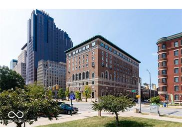 Beautiful exterior shot of a brick building in a cityscape with mature trees and manicured lawn at 350 N Meridian St # 205, Indianapolis, IN 46204