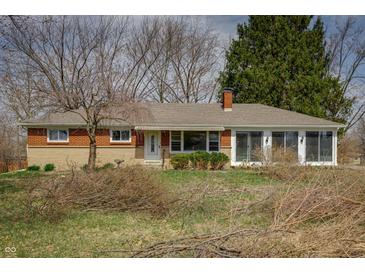 Charming brick home featuring a well-maintained lawn and mature trees at 3510 Chamberlin Dr, Indianapolis, IN 46237