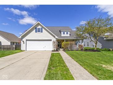 Charming home with a two-car garage, landscaped front yard, and inviting front porch at 3856 Cornwallis Ln, Carmel, IN 46032