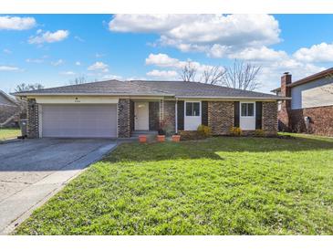 Charming single-story brick home with an attached garage and a well-maintained front lawn at 4744 Whirlaway Dr, Indianapolis, IN 46237