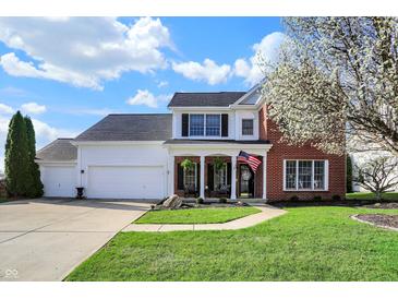 Charming two-story home with a well-manicured lawn, front porch, and attached two car garage at 8107 Parcrest Ct, Indianapolis, IN 46259