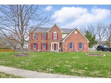 Charming two-story brick home with red shutters and a well-manicured lawn at 8414 Anchorage Ct, Indianapolis, IN 46236