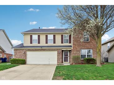 Charming two-story home with a two-car garage, brick facade, and well-maintained lawn at 8650 N Springview Dr, McCordsville, IN 46055