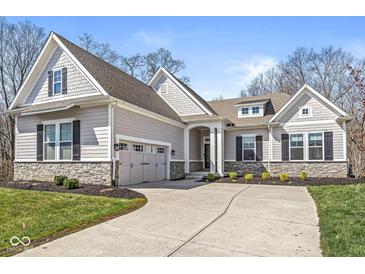 Charming single-Gathering home showcasing professional landscaping, a stone foundation, and inviting curb appeal at 11172 Cliffside Dr, Fortville, IN 46040
