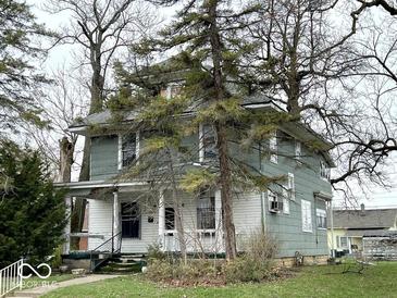 Charming two-story home with a covered front porch and mature trees in a residential neighborhood at 1325 S Hackley St, Muncie, IN 47302