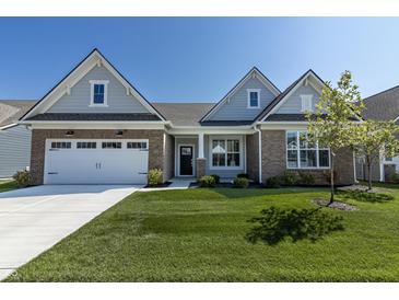 Charming single-Gathering home with a brick-accented facade, attached garage, and meticulously maintained lawn at 19771 Sutton Ter, Westfield, IN 46074