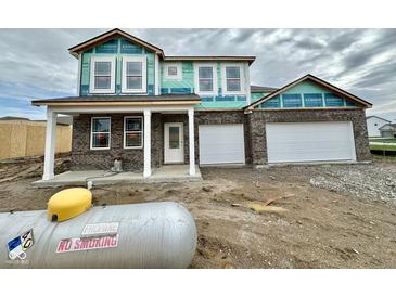 New two-story brick home featuring an attached two-car garage and covered front porch at 240 Ames Dr, Whiteland, IN 46184