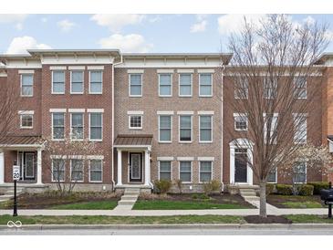 Charming brick townhome with manicured lawn and inviting entrance, creating great curb appeal at 2618 Congress St, Carmel, IN 46032