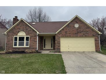 Charming brick home with attached garage and well-maintained lawn at 3734 Ontario Cir, Indianapolis, IN 46268