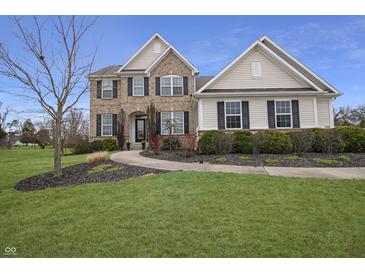 Charming two-story home featuring a manicured lawn and walkway leading to the front entrance at 4733 Mecklenburg Dr, Plainfield, IN 46168