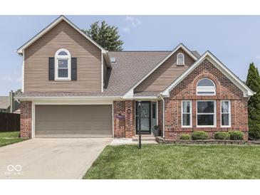 Charming two-story home with a well-manicured lawn and beautiful brick and siding accents at 1228 Easton Point Dr, Greenwood, IN 46142