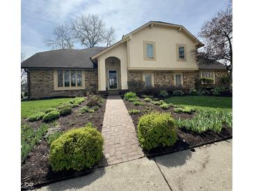 Charming exterior with brick walkway and lovely landscaping in the front yard at 1813 Birch Dr, Plainfield, IN 46168