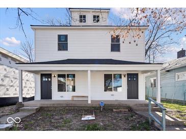 Charming two-story home featuring a covered front porch with white accents and black doors at 241 N Tacoma Ave, Indianapolis, IN 46201