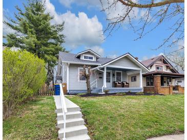 Charming home featuring a welcoming front porch with seating and well-maintained landscaping at 2737 Napoleon St, Indianapolis, IN 46203
