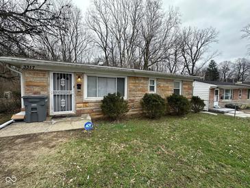 Charming single-story home featuring a stone facade and a well-maintained front yard at 3317 Adams St, Indianapolis, IN 46218