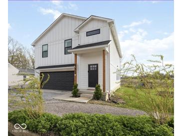 Charming two-story modern farmhouse exterior with a black garage door and landscaping at 431 W Main St, Lizton, IN 46149